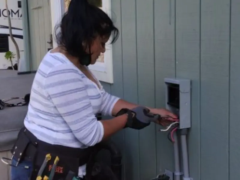 Licensed electrician wiring an exterior subpanel in Wrightstown
